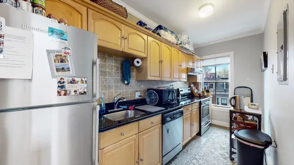 a kitchen with stainless steel appliances a sink a stove and a refrigerator