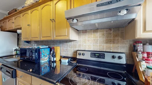 a kitchen with a stove and cabinets