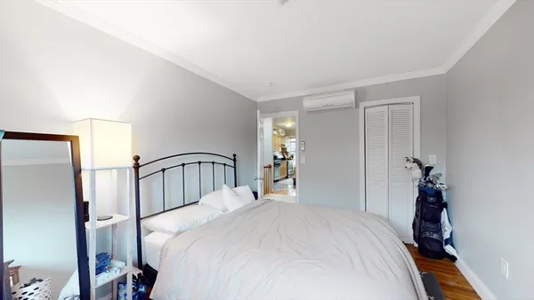 a bedroom with a bed and a large mirror