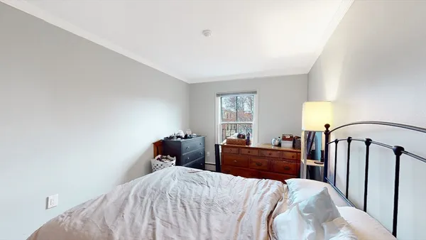 a bedroom with a bed and window