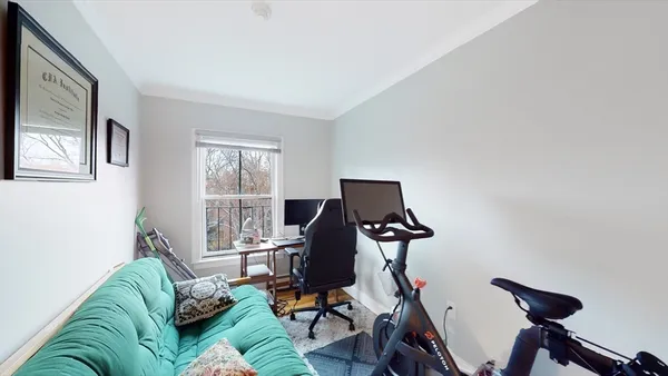 a living room with furniture a flat screen tv and a window