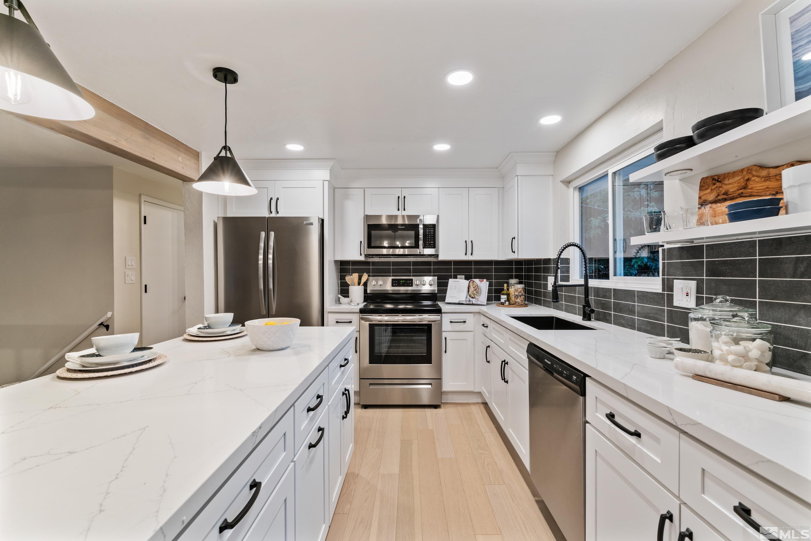 1835 Carlin Street Reno, NV 89503 - Photo 8 of 40 a kitchen with stainless steel appliances kitchen island granite countertop a sink and cabinets