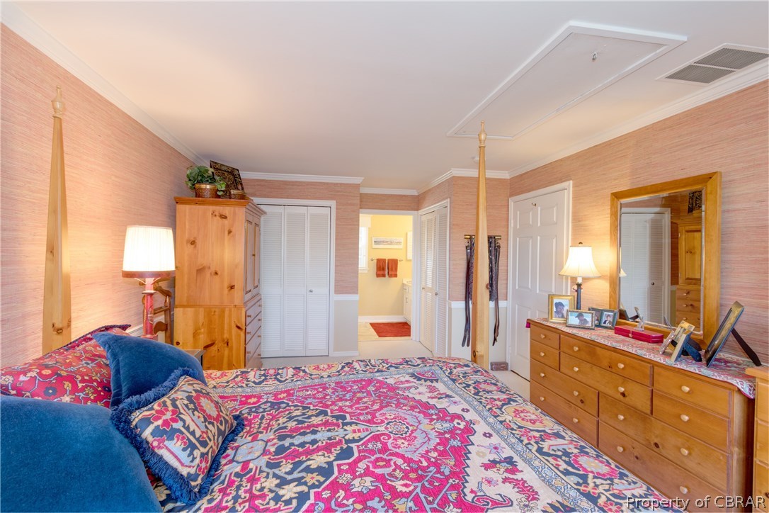 273 Cove Colony Road Lancaster, VA 22503 - Photo 31 of 46 a bedroom with a bed and a dresser in it