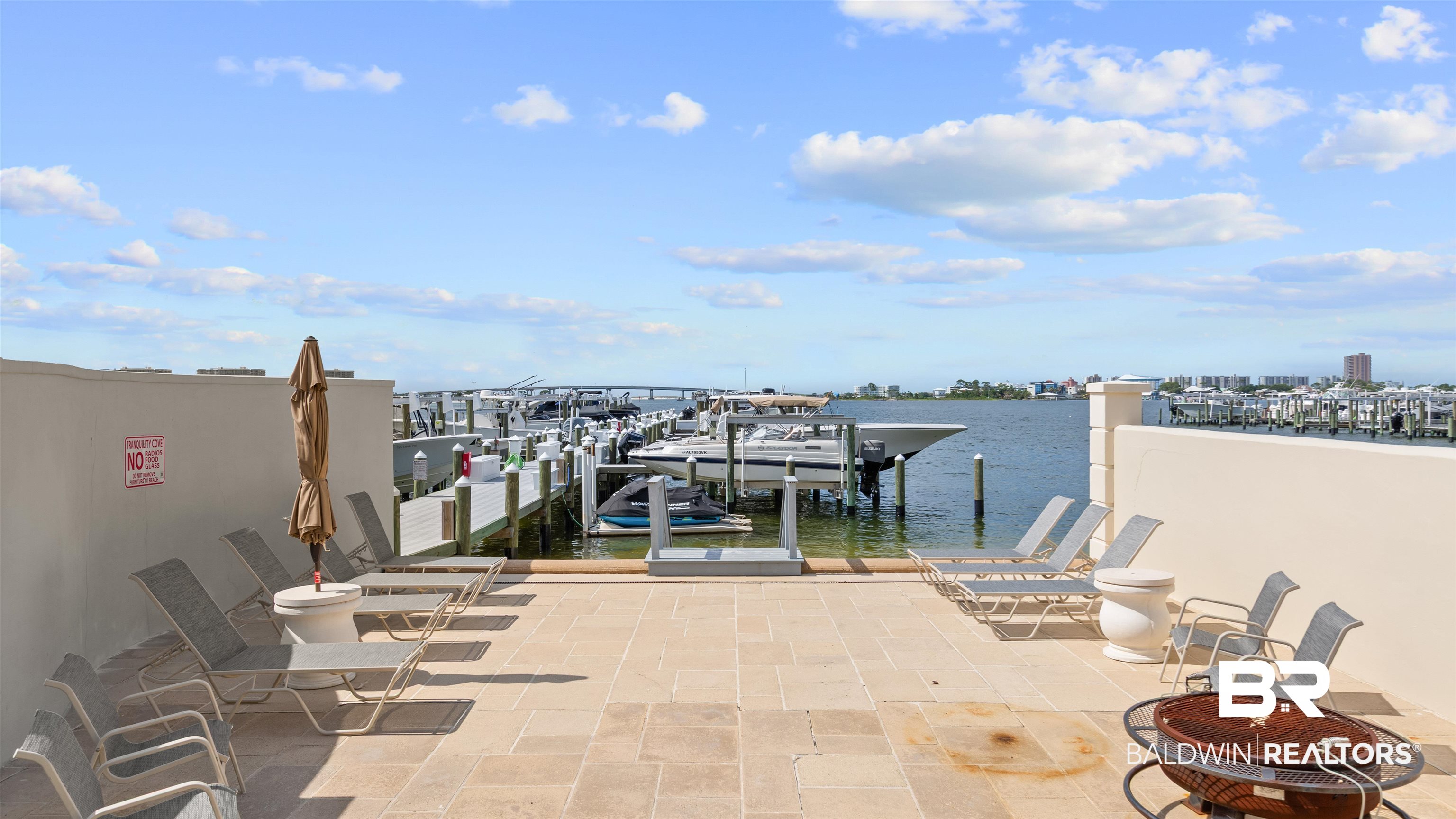 27582 Canal Road, Unit 2207 Orange Beach, AL 36561 - Photo 20 of 25 Dock area with boat lift, a water view, and a fire pit