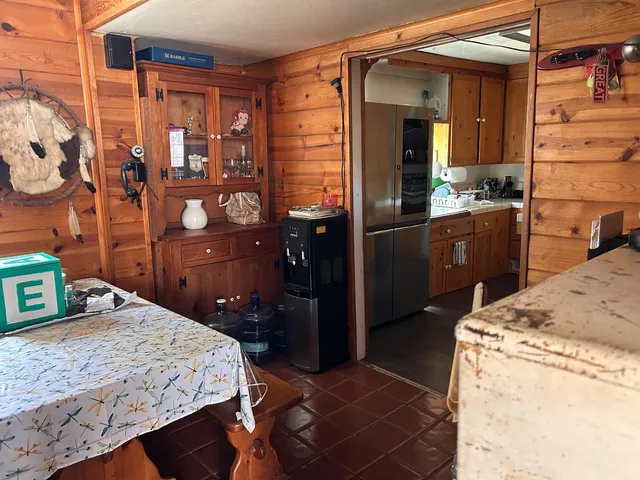 a bedroom with a bed and wooden cabinets