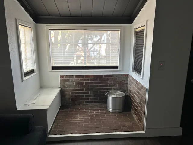 a bathroom with a sink a toilet and window