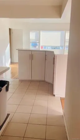 a view of a refrigerator and window in a kitchen