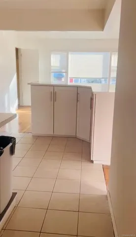 a view of a refrigerator and window in a kitchen
