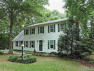 9809 Gralyn Road Raleigh, NC 27613 - Photo 1 of 1 a house that has a tree in front of a house