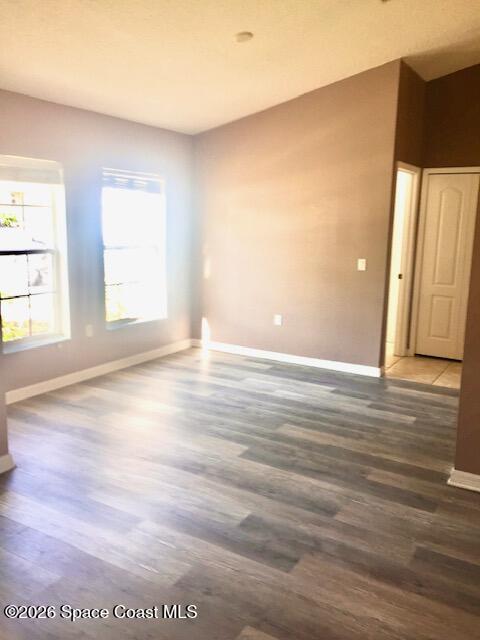 2033 Gloria Circle Palm Bay, FL 32905 - Photo 7 of 28 an empty room with wooden floor and windows