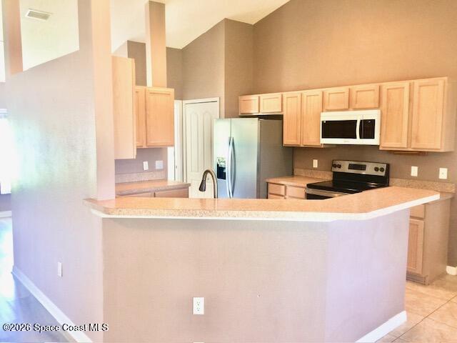 2033 Gloria Circle Palm Bay, FL 32905 - Photo 8 of 28 a kitchen with stainless steel appliances a sink a stove a microwave a refrigerator a counter top oven and cabinets