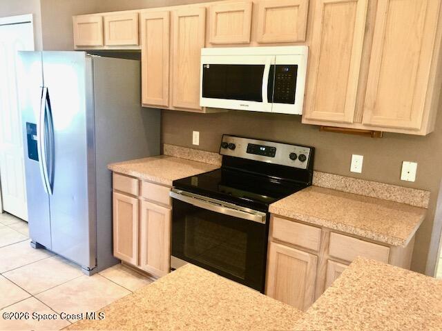 2033 Gloria Circle Palm Bay, FL 32905 - Photo 9 of 28 a kitchen with stainless steel appliances granite countertop a stove a refrigerator and a microwave
