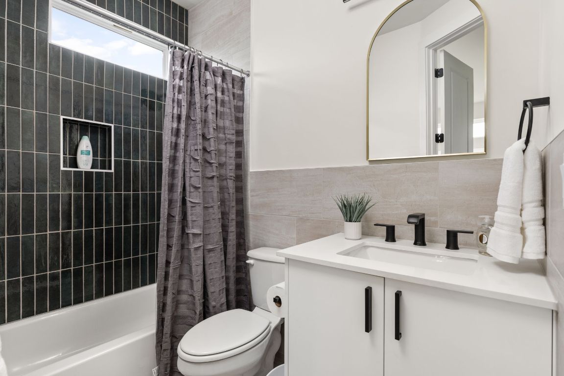 1402 Summit Street, Unit A Austin, TX 78741 - Photo 12 of 30 a bathroom with a sink toilet and shower