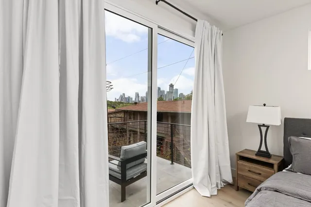 a bedroom with a bed wooden floor and a lamp