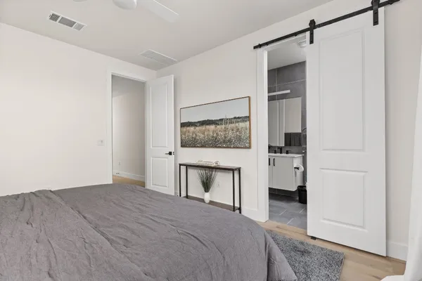 a bedroom with a bed and a mirror