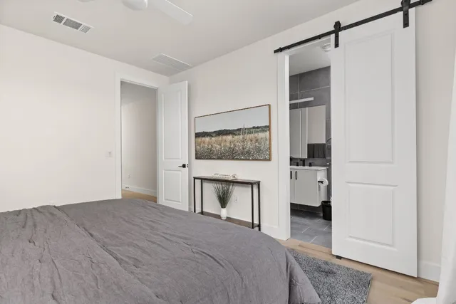 a bedroom with a bed and a mirror