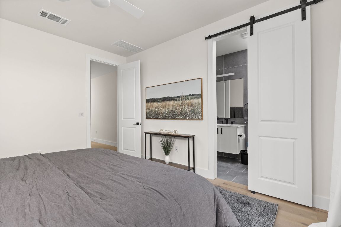 1402 Summit Street, Unit A Austin, TX 78741 - Photo 16 of 30 a bedroom with a bed and a mirror