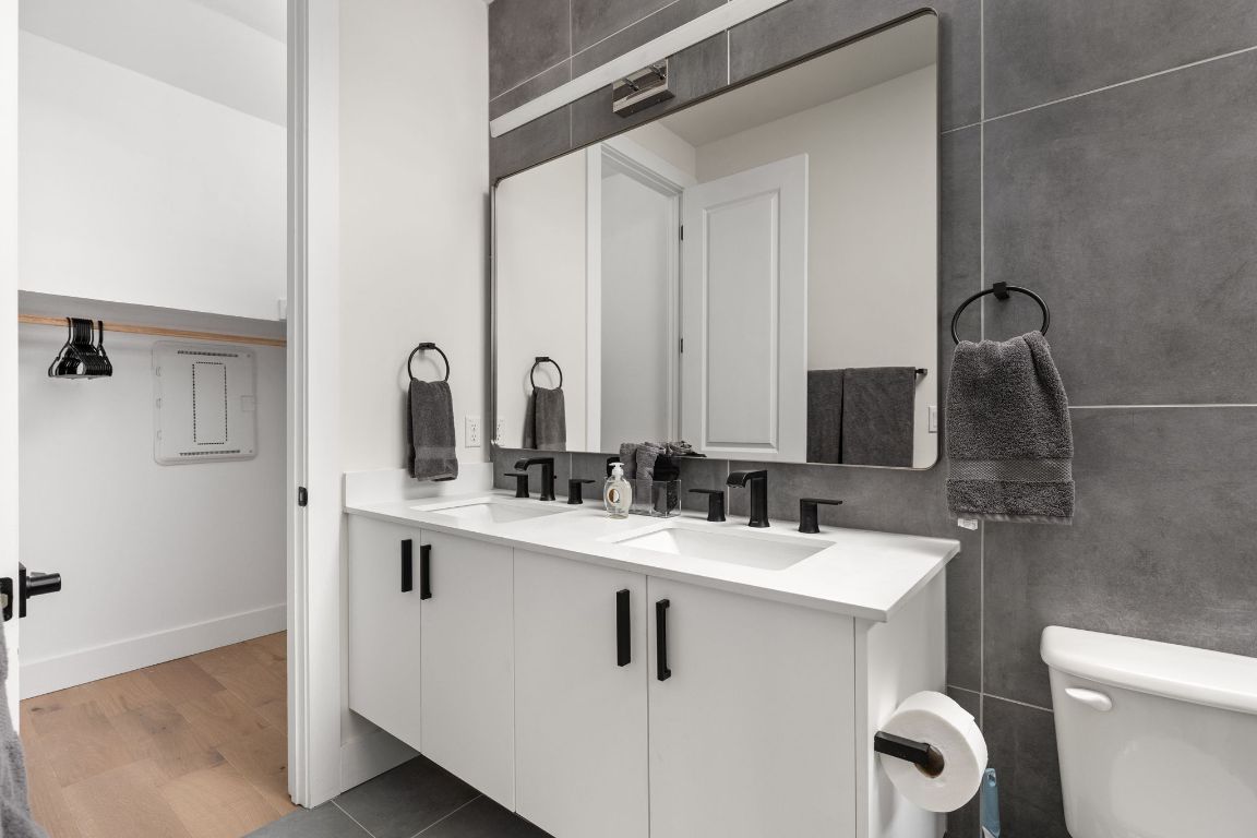 1402 Summit Street, Unit A Austin, TX 78741 - Photo 17 of 30 a bathroom with a sink toilet and mirror