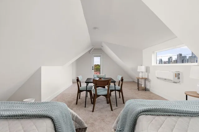 a bedroom with furniture and white walls