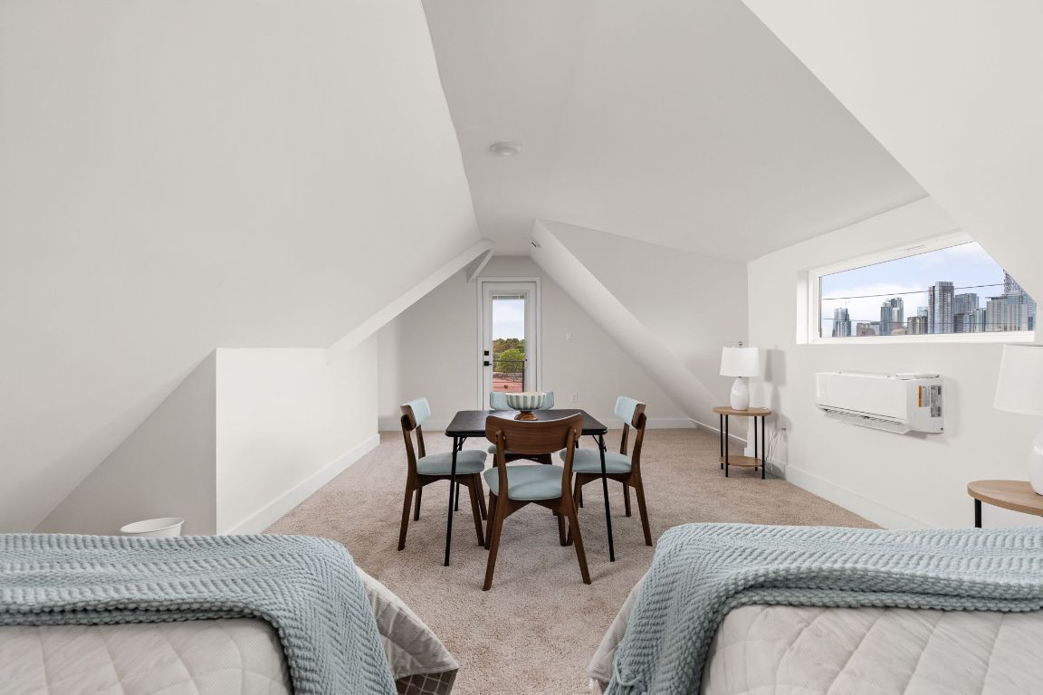 1402 Summit Street, Unit A Austin, TX 78741 - Photo 21 of 30 a bedroom with furniture and white walls