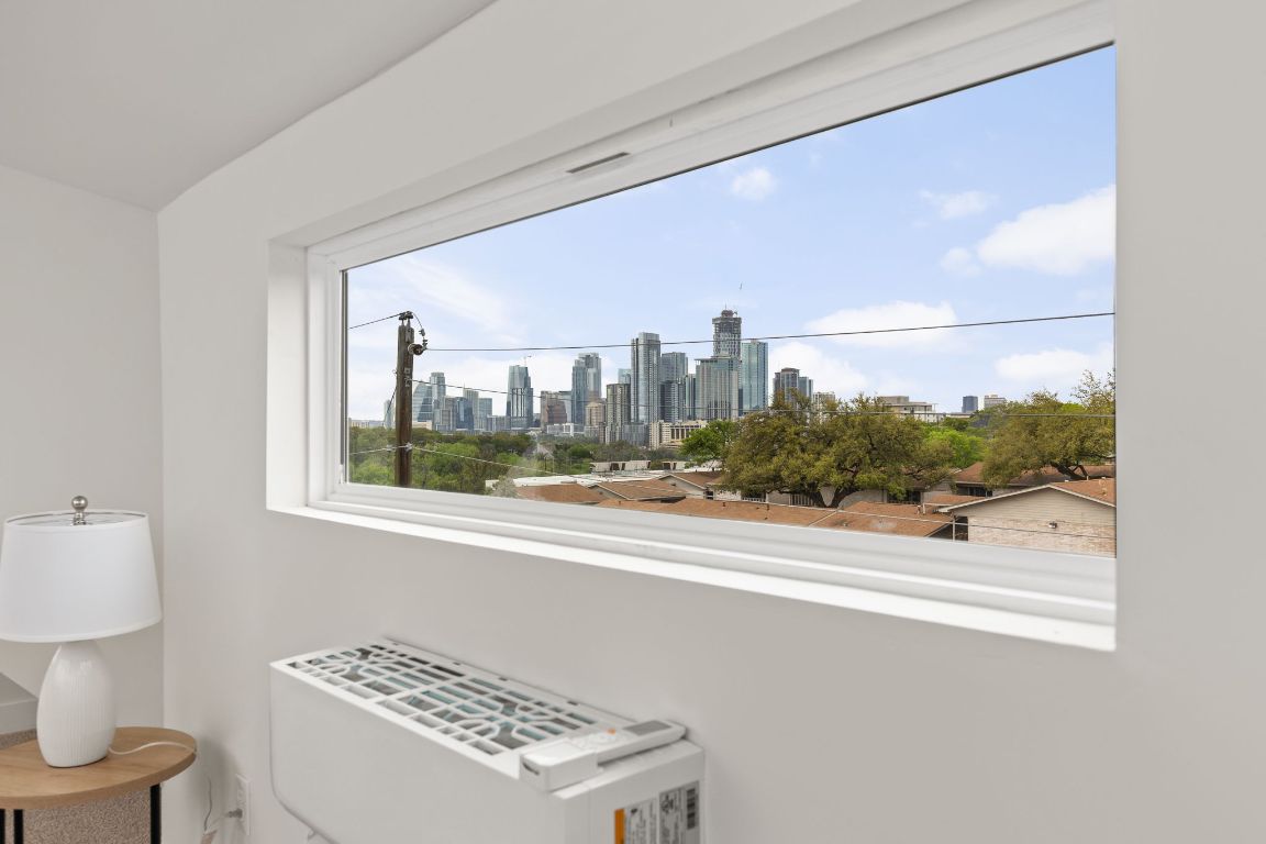 1402 Summit Street, Unit A Austin, TX 78741 - Photo 22 of 30 a view of a room that has a bed and a dresser in it