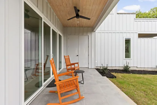 a backyard of a house with table and chairs