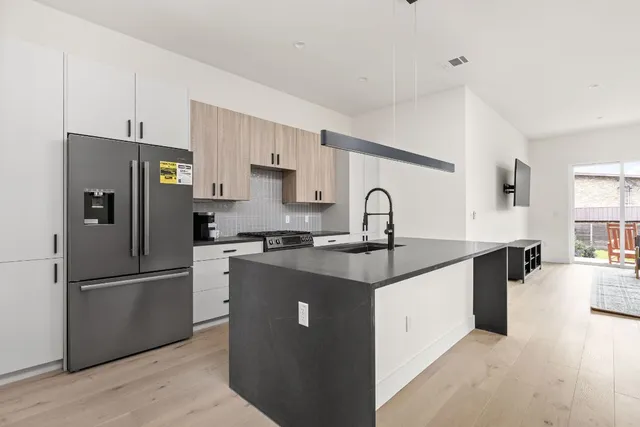 a kitchen with stainless steel appliances granite countertop a stove and a sink