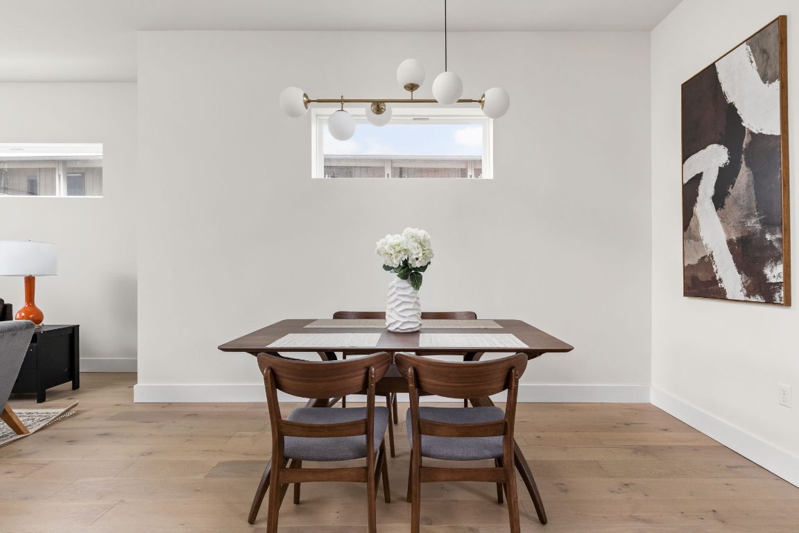 1402 Summit Street, Unit A Austin, TX 78741 - Photo 5 of 30 a view of a dining room with furniture and wooden floor