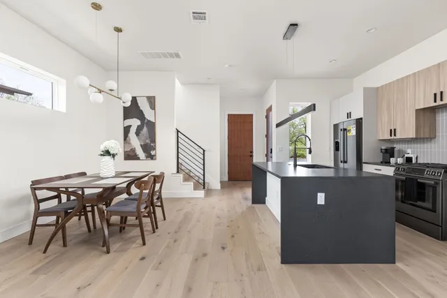 a view of a dining room with furniture and wooden floor