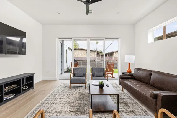 a view of a dining room with furniture and wooden floor