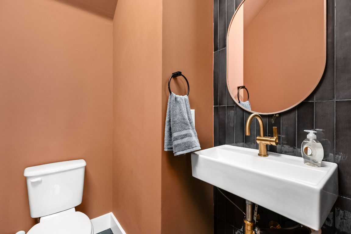 1402 Summit Street, Unit A Austin, TX 78741 - Photo 9 of 30 a bathroom with a sink and a mirror