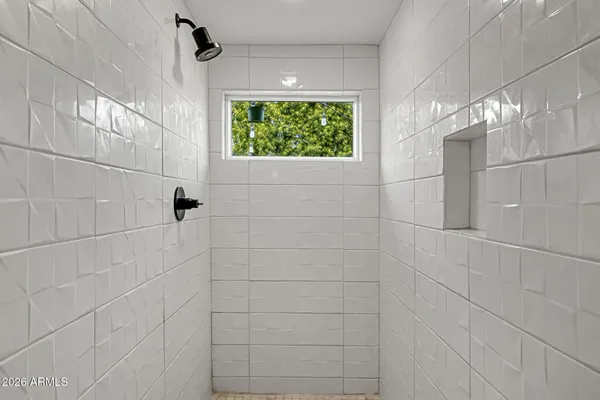 a bathroom with a window and a shower