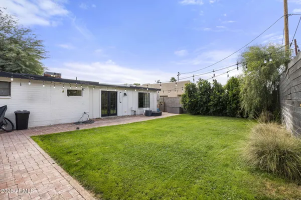 a backyard of a house with table and chairs
