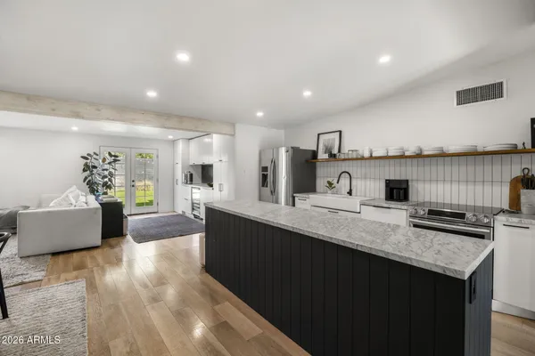 a kitchen with granite countertop a sink and a stove top oven