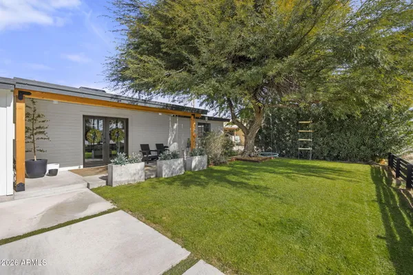 a front view of a house with garden and patio