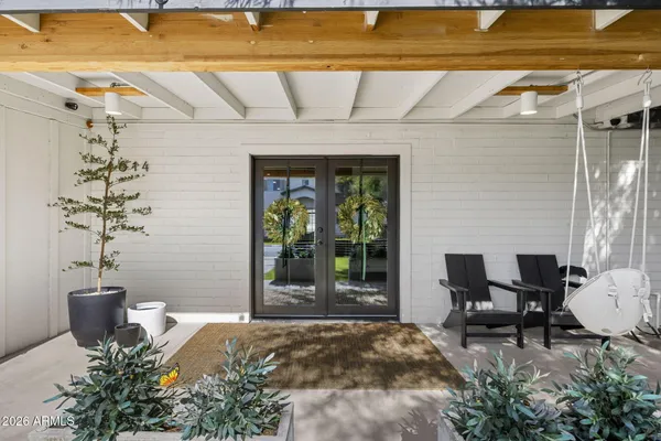 a view of a patio with table and chairs and potted plants