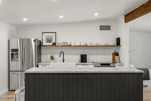 a kitchen with refrigerator and cabinets