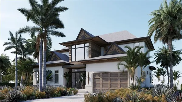 a front view of a house with a tree