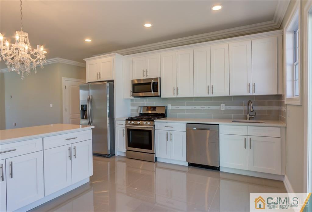 98 Winthrop Road Edison, NJ 08817 - Photo 3 of 6 a kitchen with cabinets stainless steel appliances and a window
