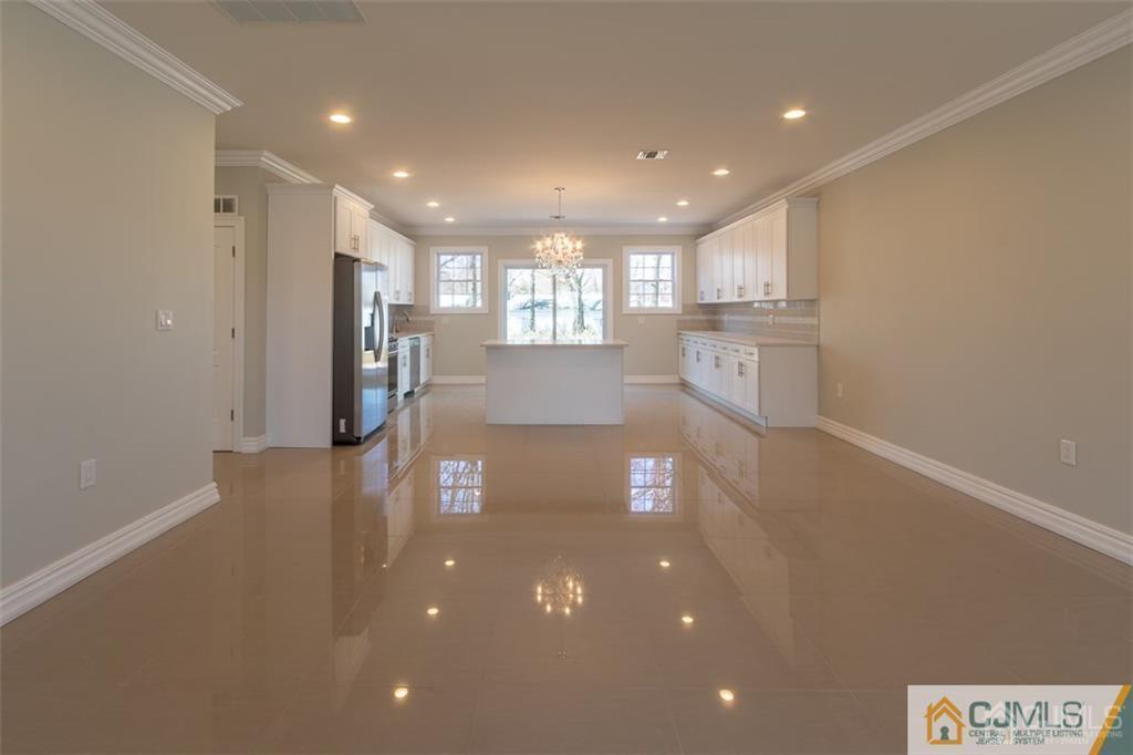 98 Winthrop Road Edison, NJ 08817 - Photo 4 of 6 a view of a living room and kitchen with a large window
