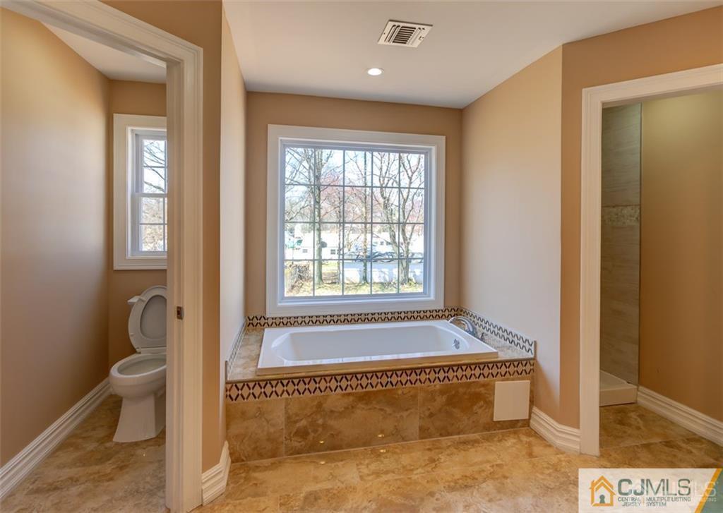 98 Winthrop Road Edison, NJ 08817 - Photo 5 of 6 a bathroom with a bathtub and window