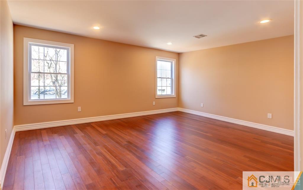 98 Winthrop Road Edison, NJ 08817 - Photo 6 of 6 a view of an empty room with wooden floor and a window