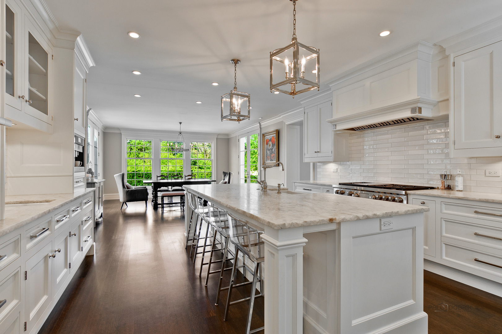 500 South Ridge Road Lake Forest, IL 60045 - Photo 20 of 54 a kitchen with stainless steel appliances granite countertop a stove top oven a sink dishwasher and a dining table with wooden floor