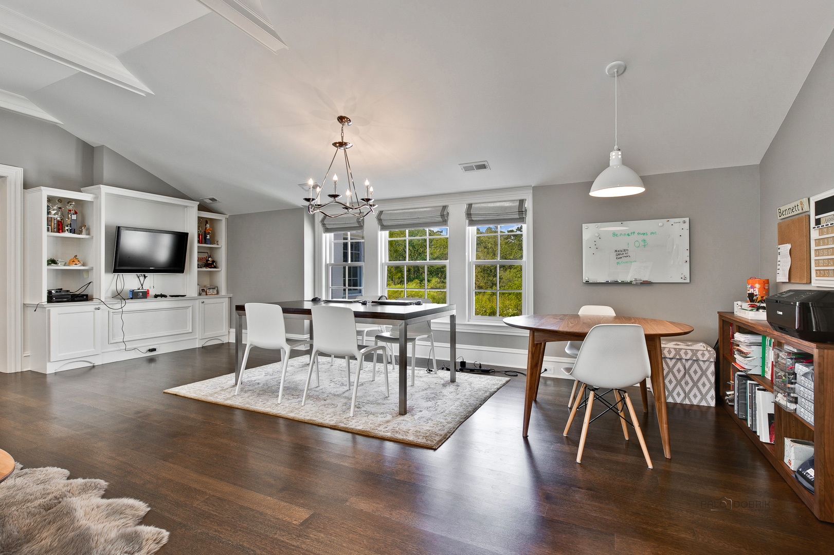 500 South Ridge Road Lake Forest, IL 60045 - Photo 29 of 54 a dining room with wooden floor a chandelier a glass table and chairs