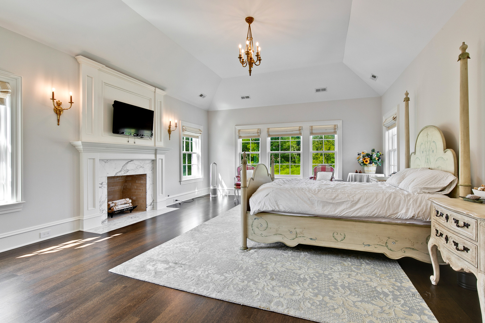 500 South Ridge Road Lake Forest, IL 60045 - Photo 32 of 54 a spacious bedroom with a bed a fireplace and a flat screen tv