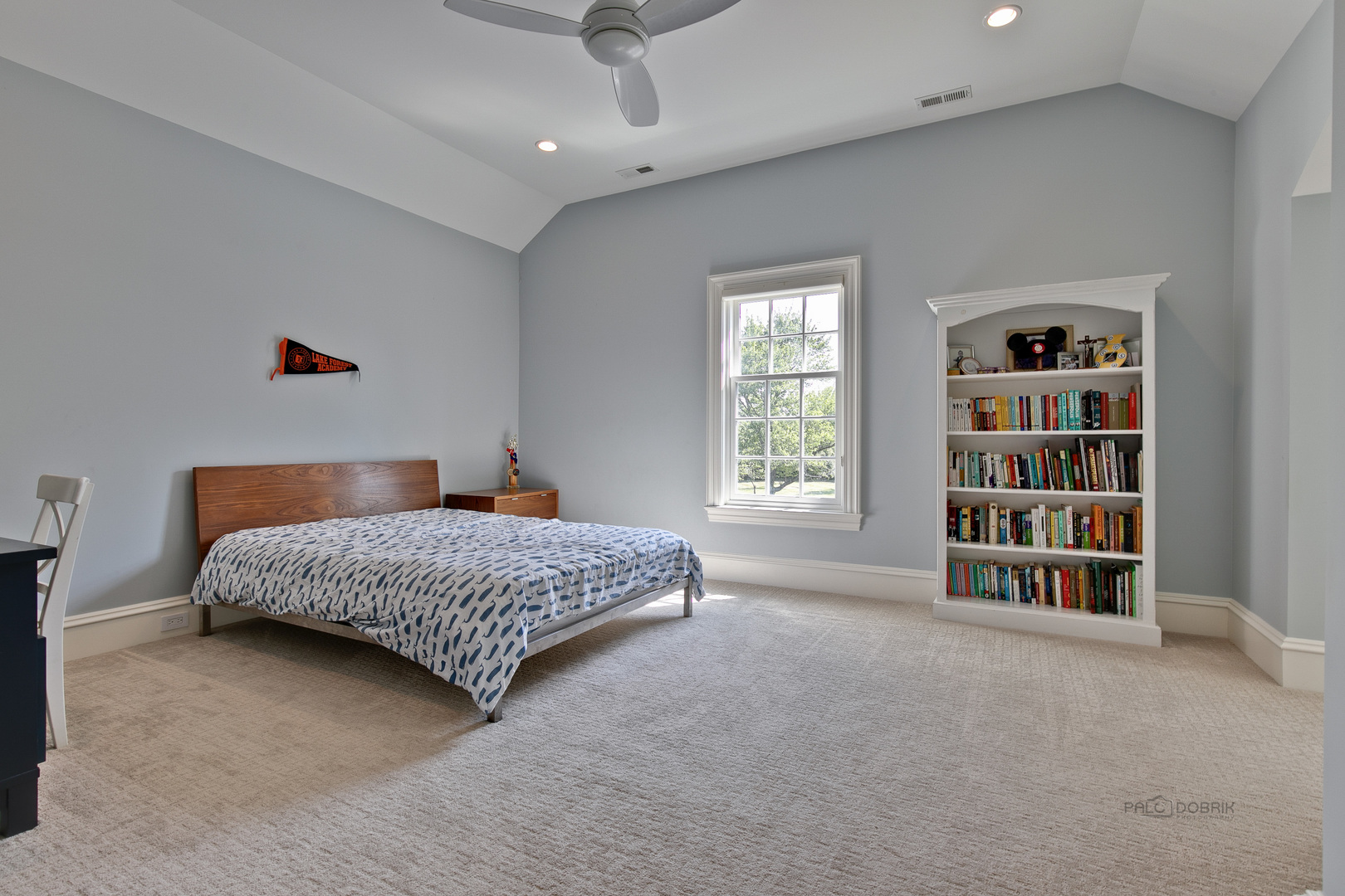 500 South Ridge Road Lake Forest, IL 60045 - Photo 40 of 54 a bedroom with a bed and a book shelf