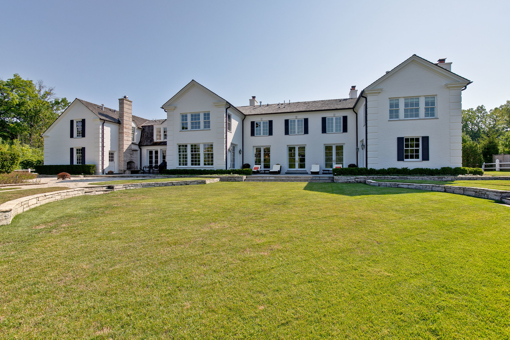 500 South Ridge Road Lake Forest, IL 60045 - Photo 50 of 54 a view of a large pool with lawn chairs and plants