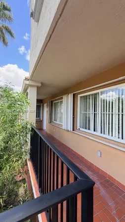 a view of balcony with deck and wooden floor