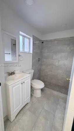 a bathroom with a sink a toilet and a shower
