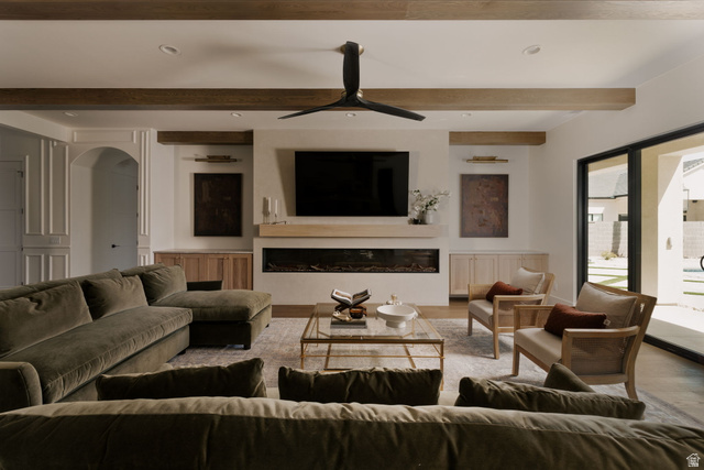 2281 South Crimson Cliffs Way St. George, UT 84790 - Photo 20 of 47 Living room featuring recessed lighting, a glass covered fireplace, a ceiling fan, wood finished floors, and arched walkways